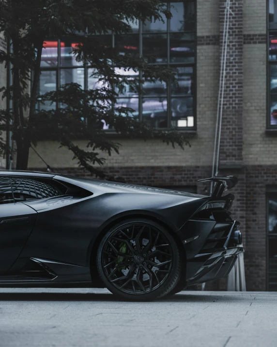 a dark colored sports car on the side of the road