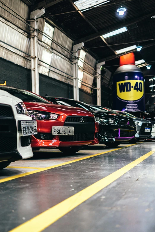 several colorful vehicles parked in a large building