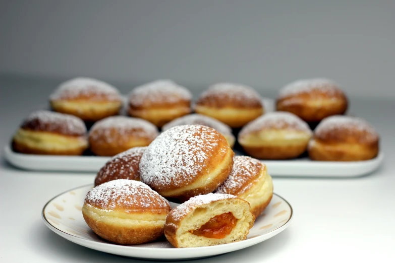 a white plate topped with donuts covered in powdered sugar, inspired by Károly Patkó, handheld, fruit, thumbnail, malt