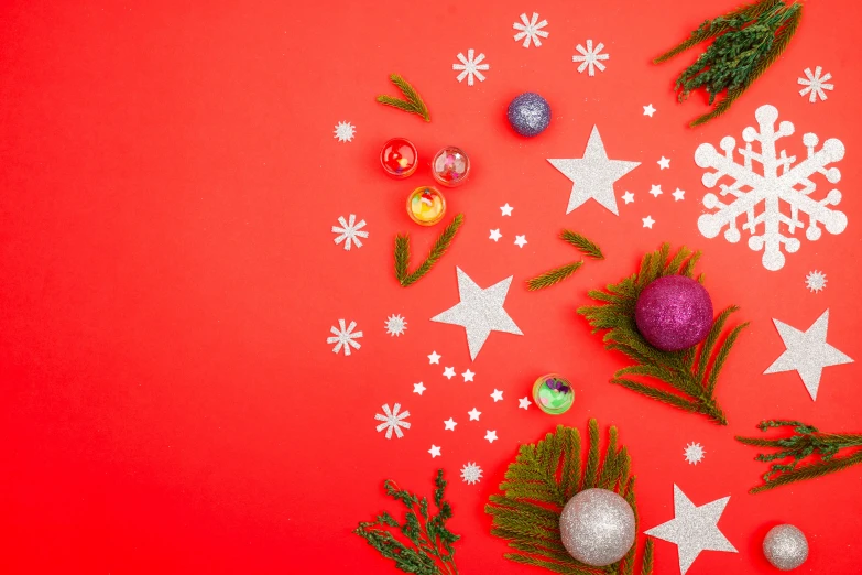 a red background covered in ornaments, snowflakes and stars