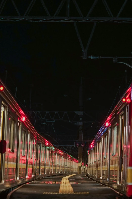 a couple of trains that are next to each other, by Giuseppe Avanzi, red leds, glimpse of red, reddish