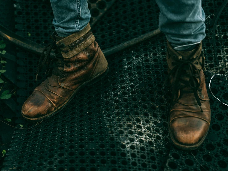 someone with boots is standing on a step