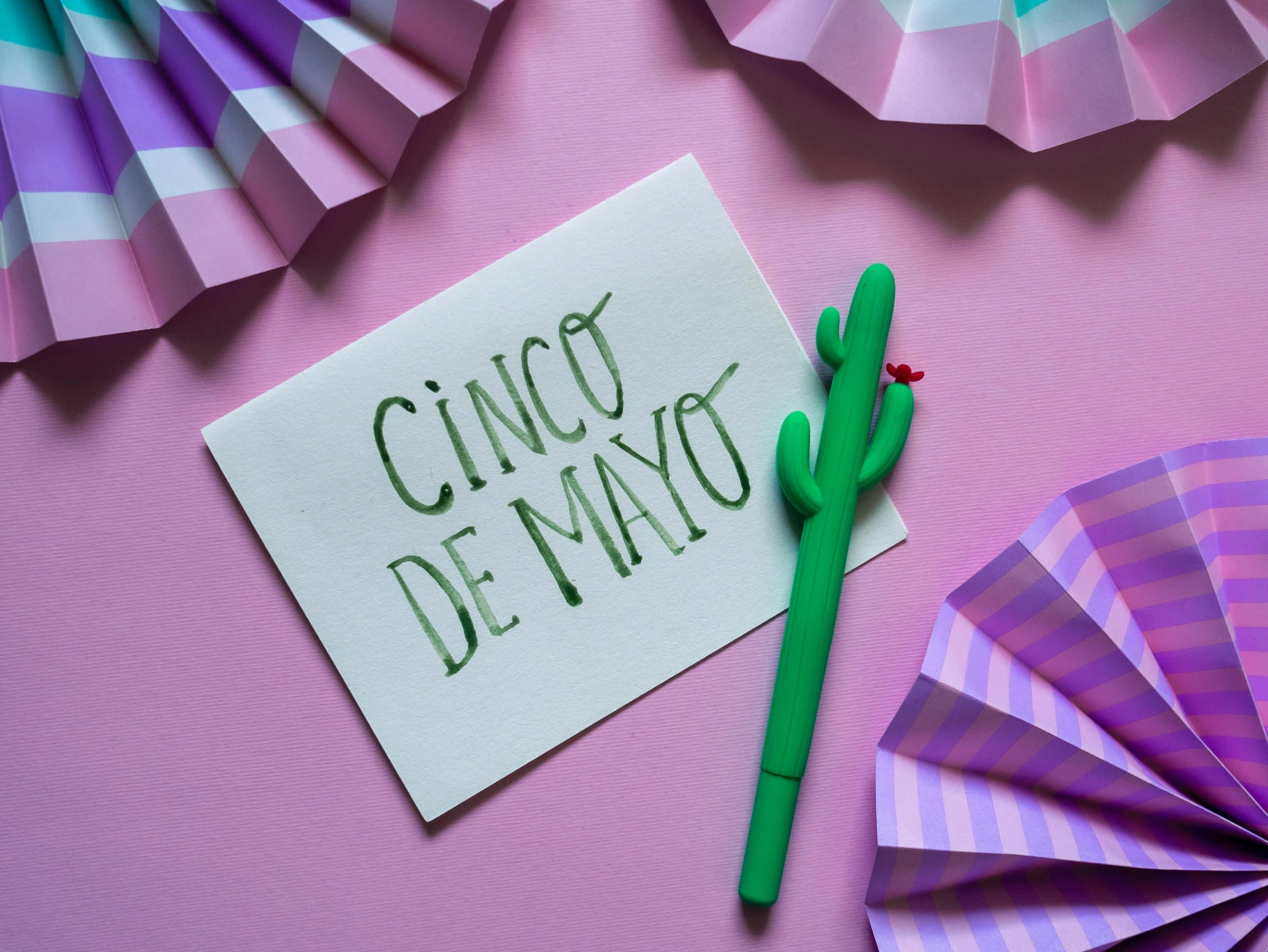 a piece of paper with the words cinco de mayo written on it, pexels contest winner, santiago calatrava, pink, crafts, day