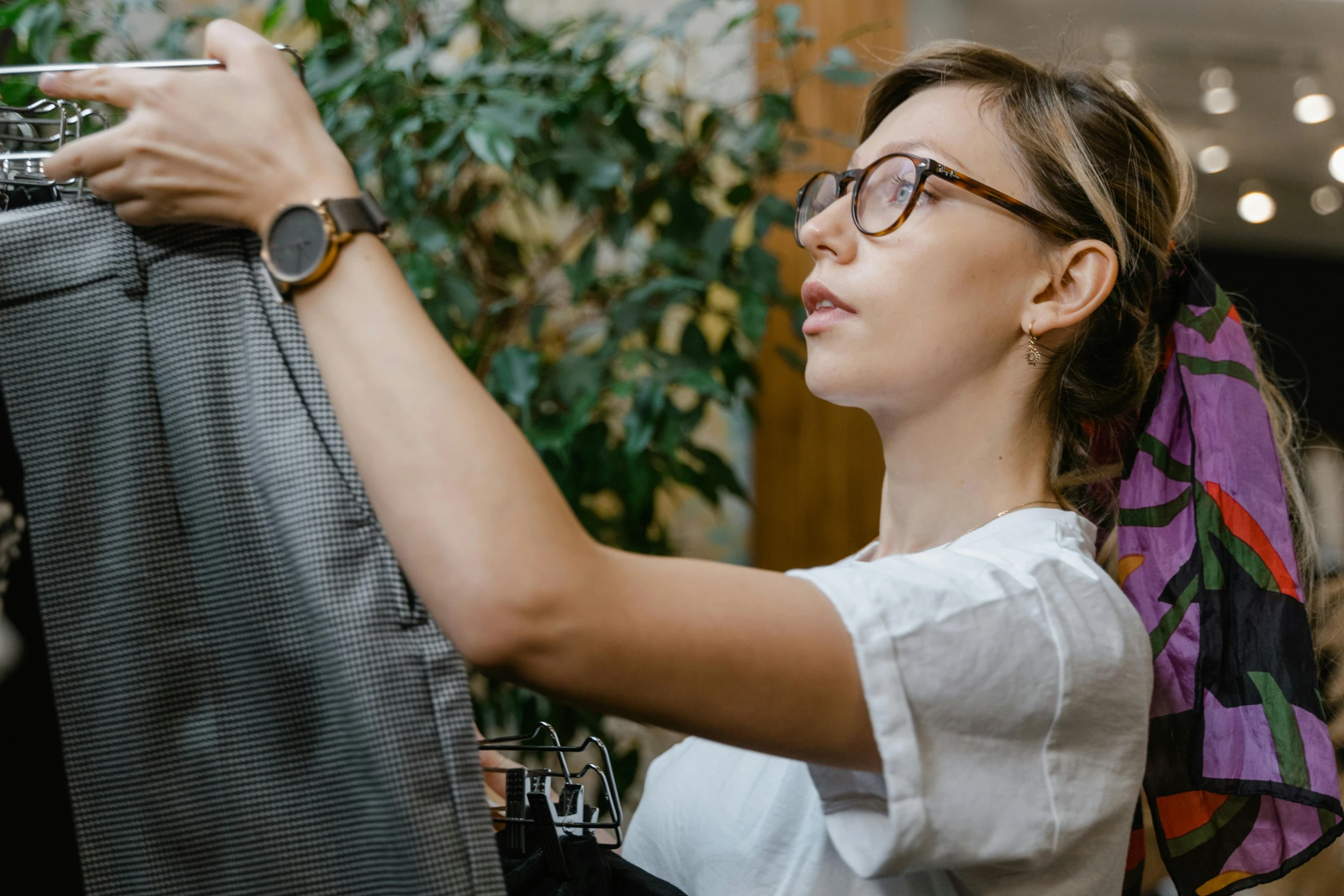 woman hanging a dress in the shape of a tie