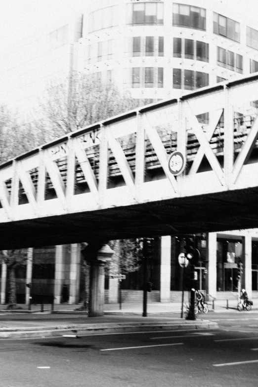 a black and white pograph shows an overpass over a street