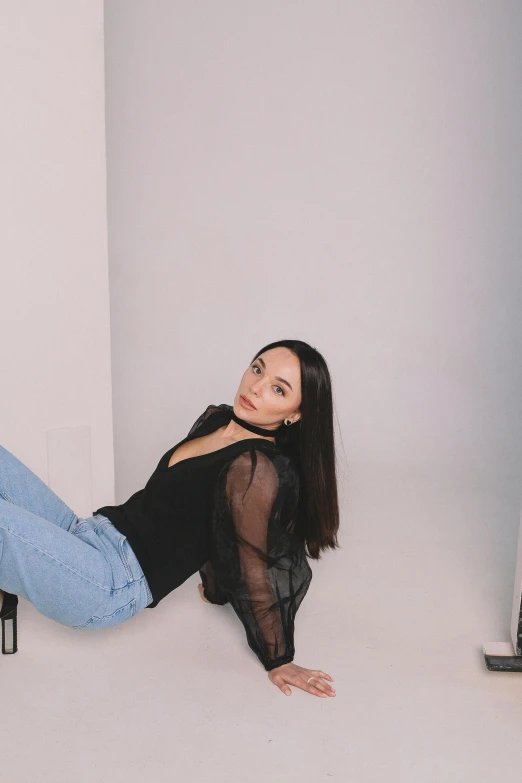 a woman is posing in a white room