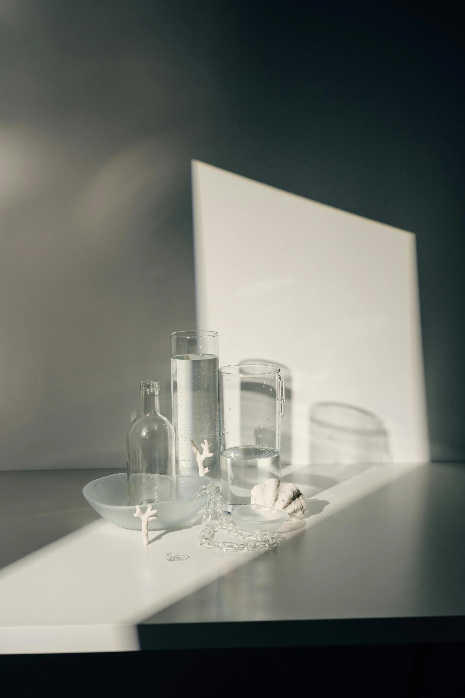 glass bottles are sitting on a table near the mirror