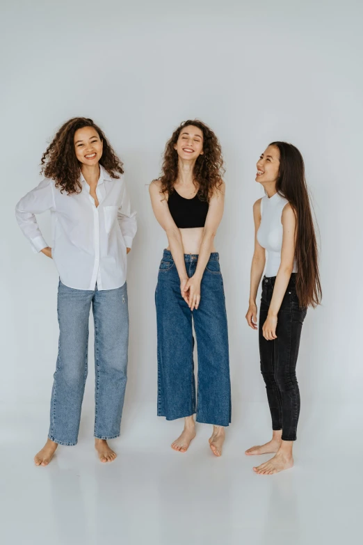 three woman are laughing while standing next to each other