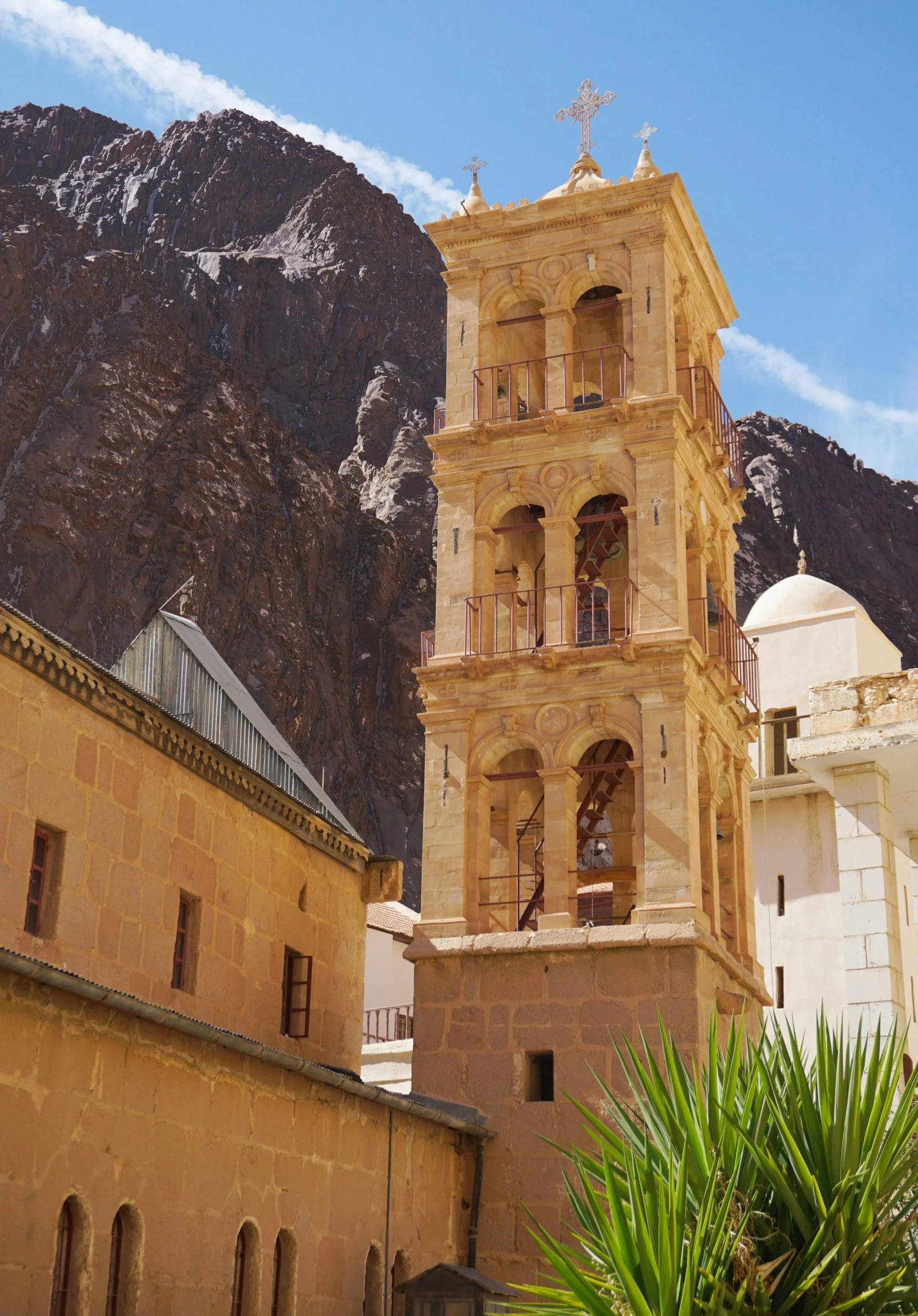 a tall tower with a clock on top of it, inspired by Antonio de la Gandara, baroque, dramatic mountains behind, muira, arabic architecture, caramel