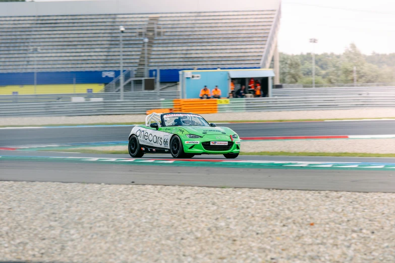 a racing car in the street with an umbrella on top