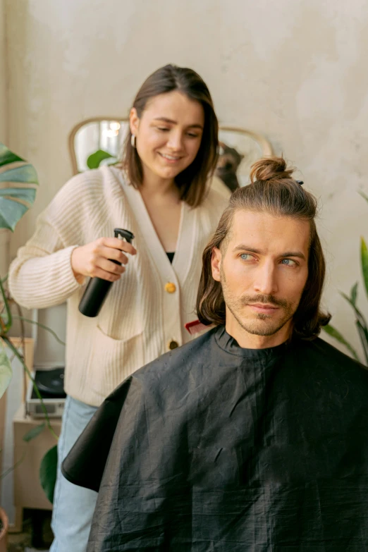 a man getting his hair cut by a woman, trending on pexels, renaissance, adam driver behind, thumbnail, product introduction photo, long ponytail