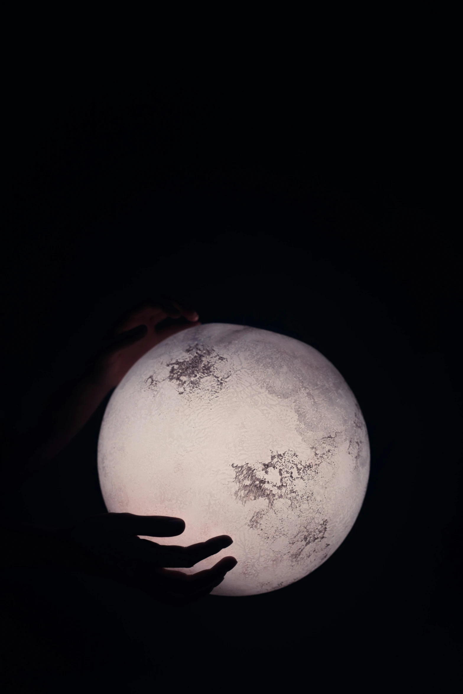 a person holding a glowing ball in the dark, an album cover, by Alison Geissler, trending on unsplash, moon craters, paper, vessels, ☁🌪🌙👩🏾