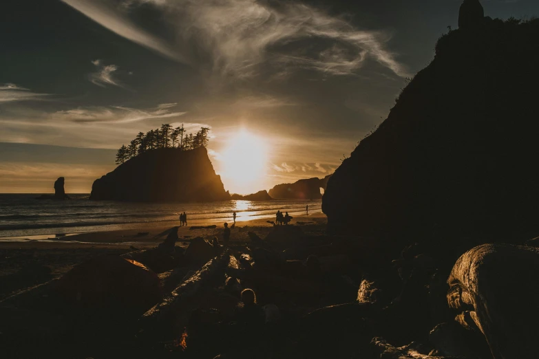 a group of people standing on top of a sandy beach, by Jessie Algie, unsplash contest winner, pacific northwest coast, sunset in a valley, goonies, hd wallpaper