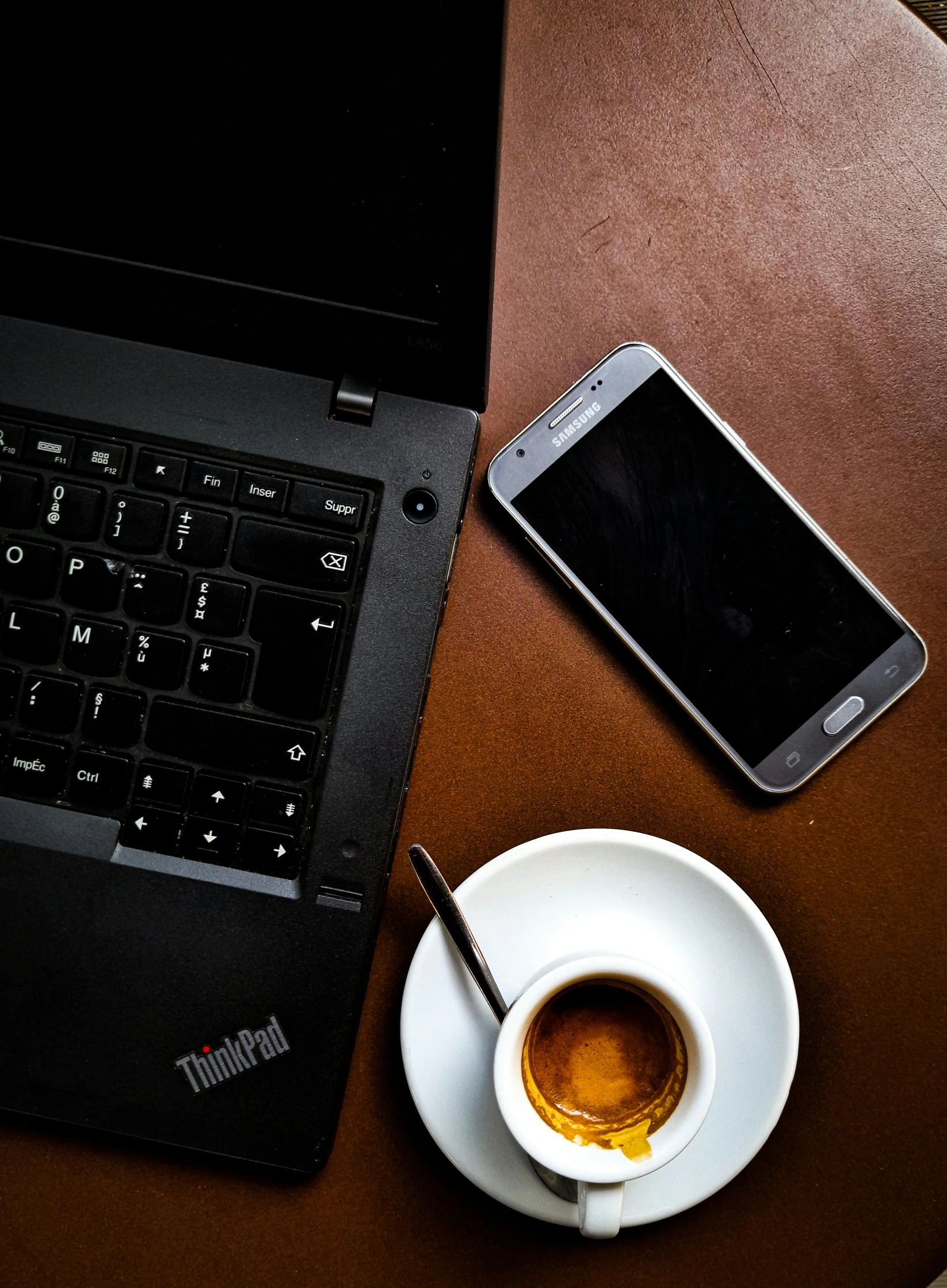 a laptop computer sitting on top of a wooden table next to a cup of coffee, by Matthias Stom, cellphone, thumbnail, thinkpad, true