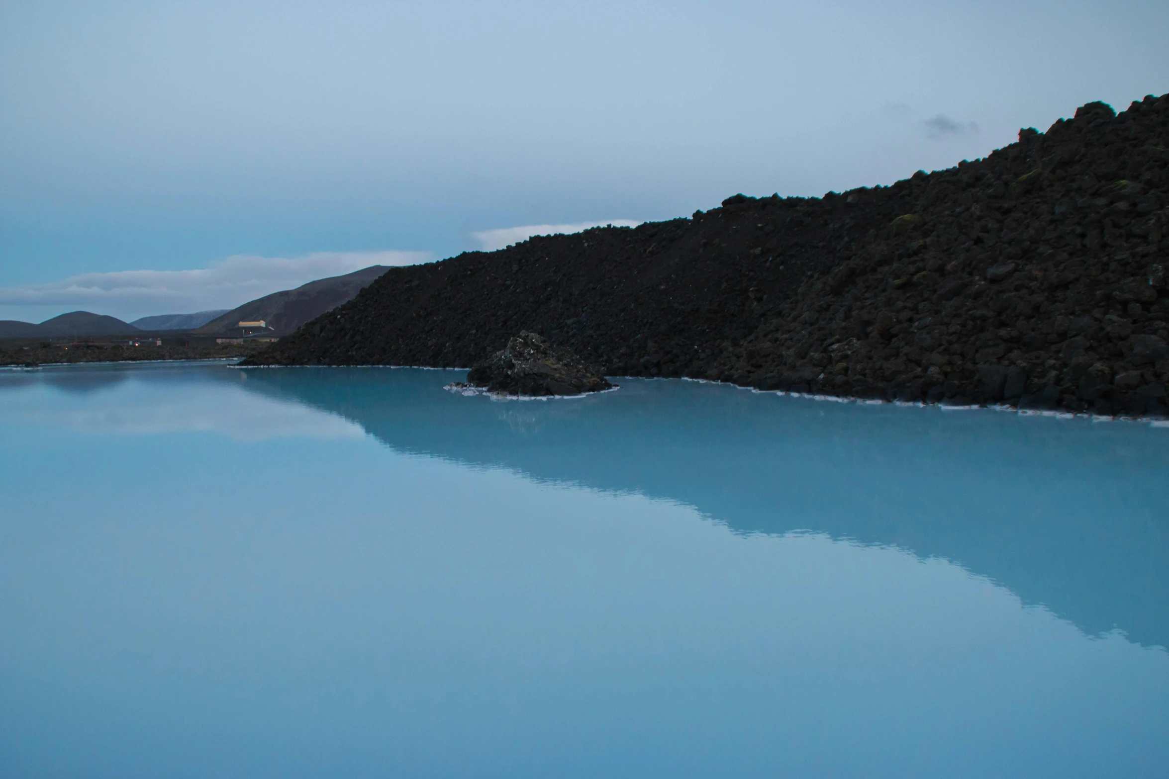 water in a lake surrounded by rocky mountains