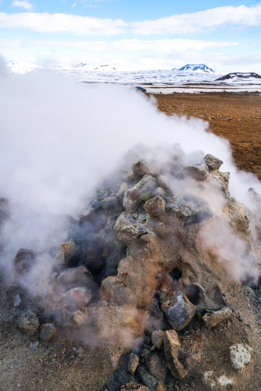 steam billowing out of the ground into the sky