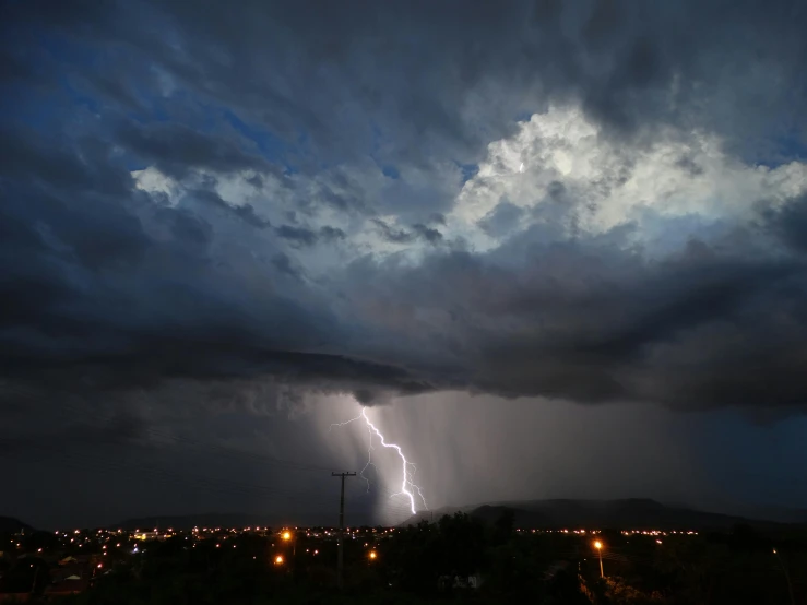 a large bolt hitting in the night sky,