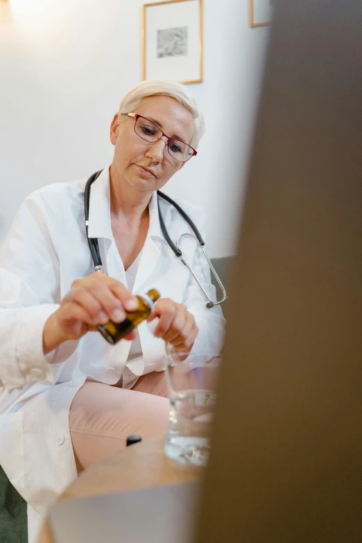 a woman with a stethoscope sitting on a couch, a picture, shutterstock, renaissance, vials, colour corrected, in a lab, thumbnail