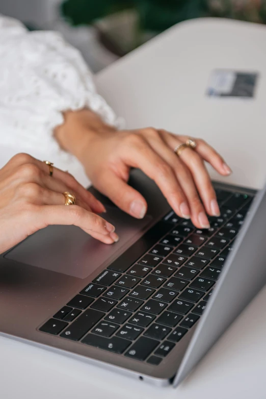 a close up of a person typing on a laptop, pexels, jen atkin, multiple stories, center of image, emily rajtkowski