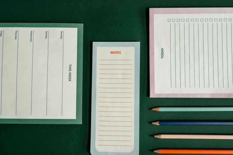 a green table topped with notebooks and pencils, inspired by Wes Anderson, trending on pexels, ui card, 3 - piece, labels, blank