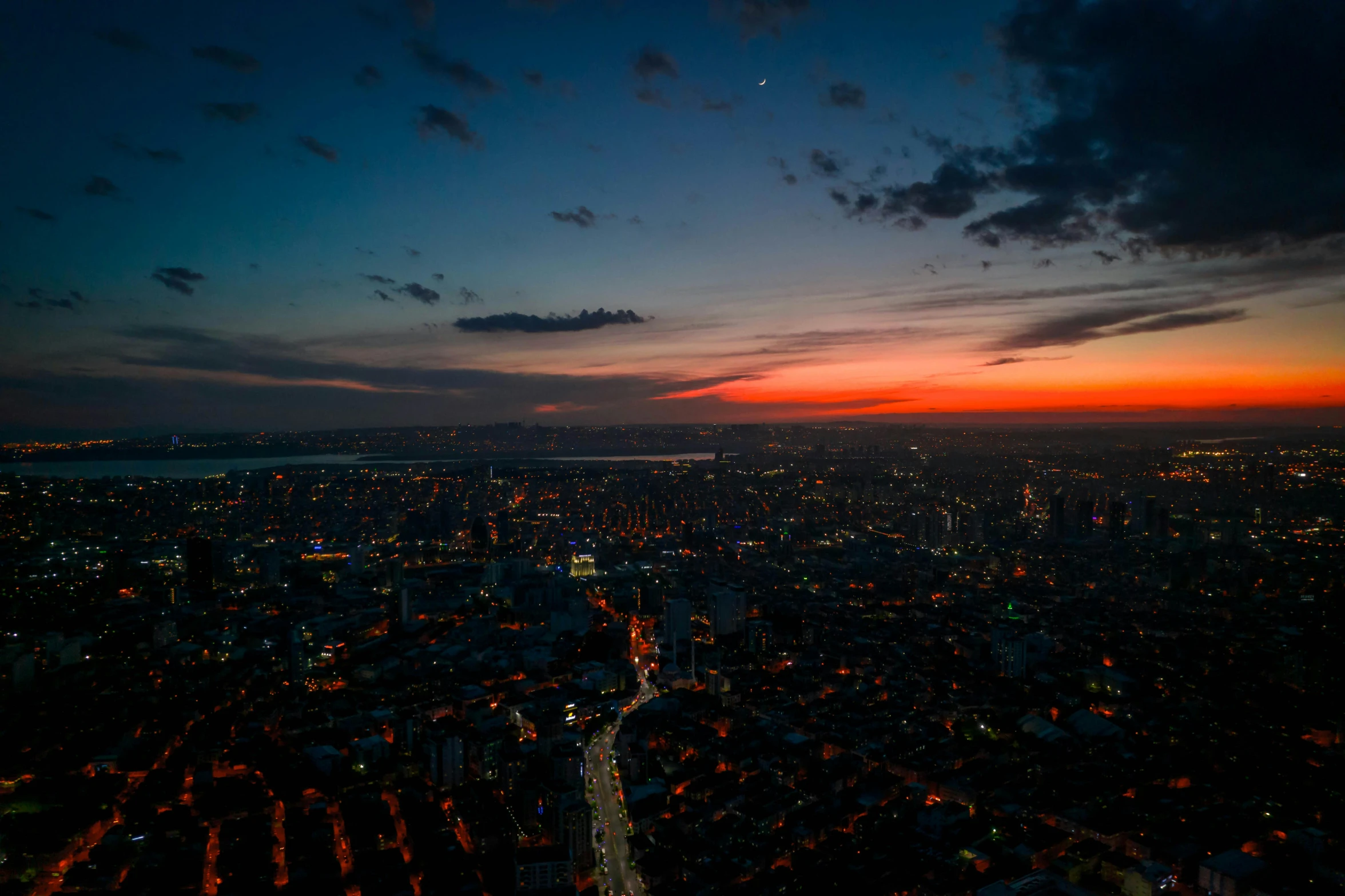 the dark city lights reflect on its surroundings at night