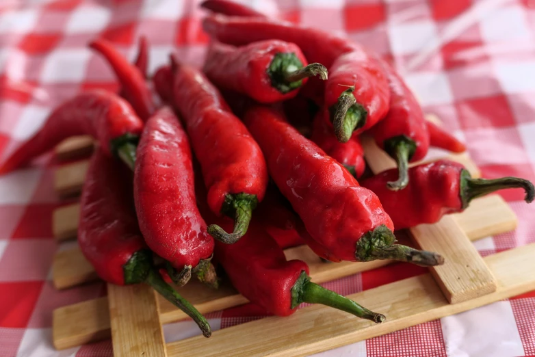 a pile of red hot peppers sitting on top of a wooden cutting board, inspired by Matteo Pérez, renaissance, avatar image, 🦩🪐🐞👩🏻🦳, very crisp details, sichuan