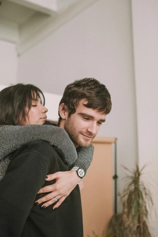 a man carrying a woman is cuddling