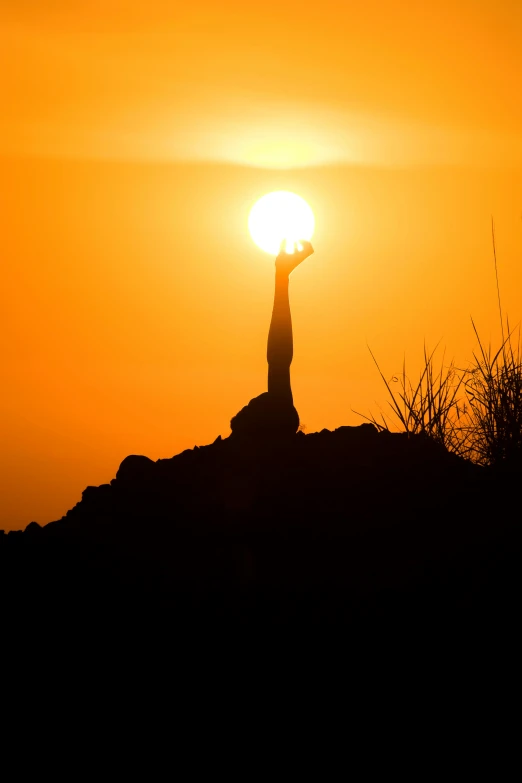 a person standing on top of a hill at sunset, yoga pose, in socotra island, bright yellow and red sun, slide show