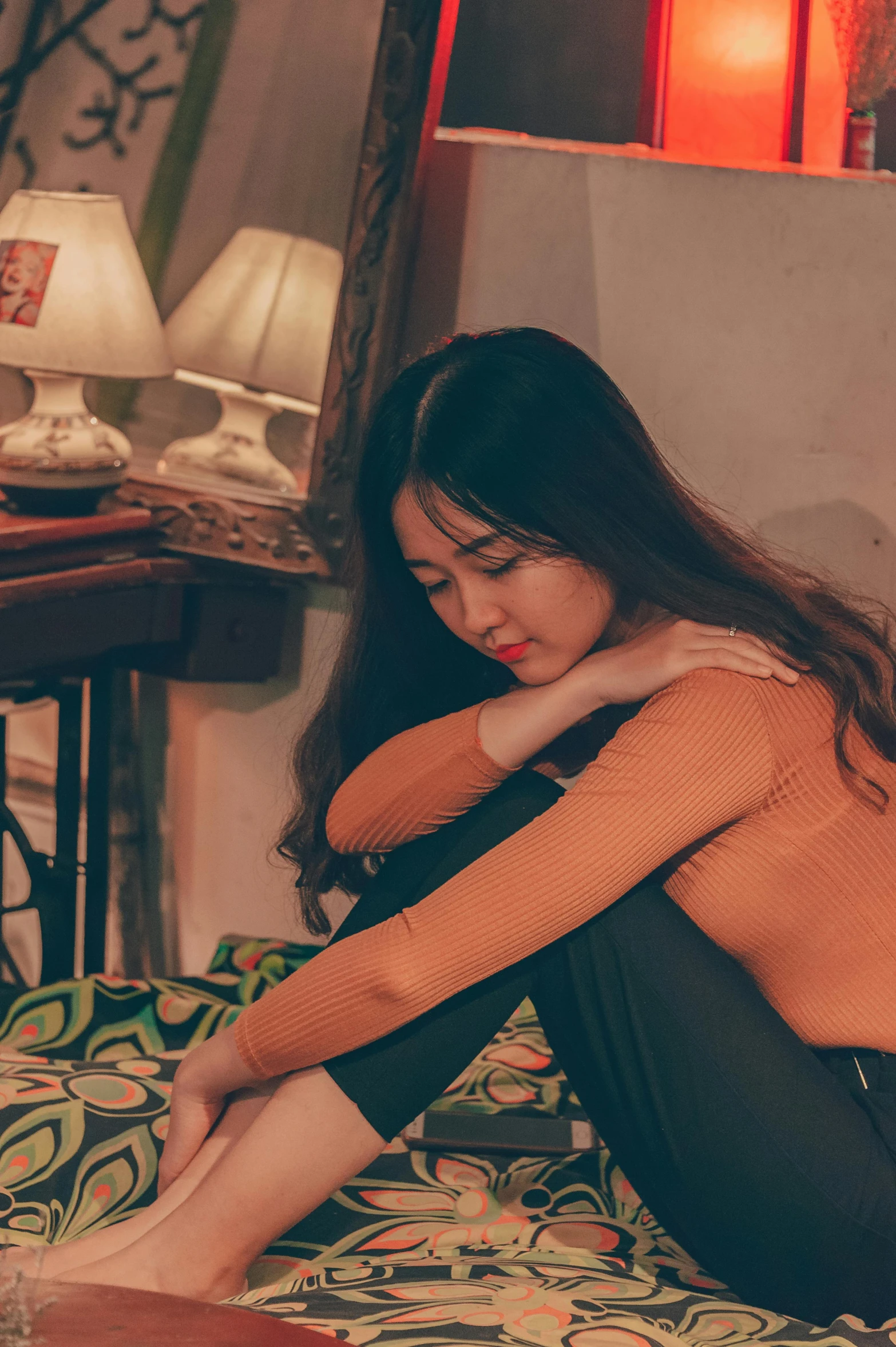 a naked woman sitting on top of a bed, a picture, inspired by Elsa Bleda, trending on pexels, visual art, heartbroken, korean girl, orange hue, vietnamese woman