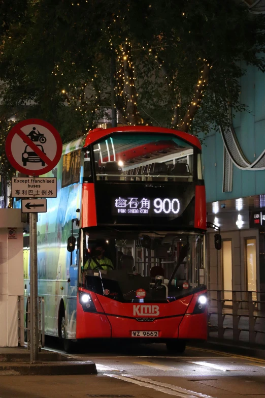 a double decker bus on the street at night