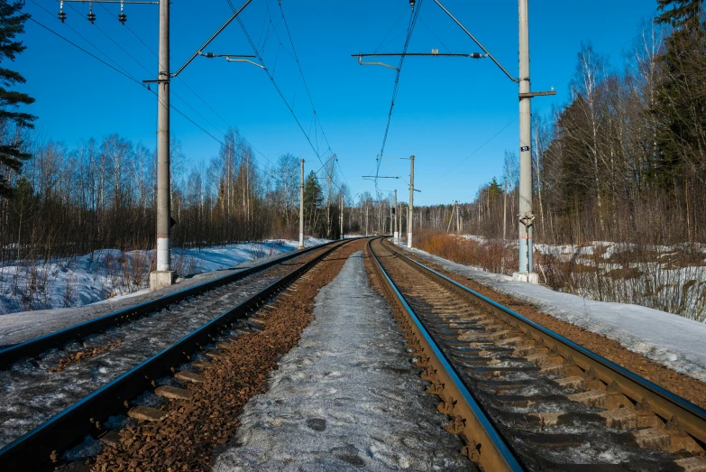 two sets of railroad tracks in the snow