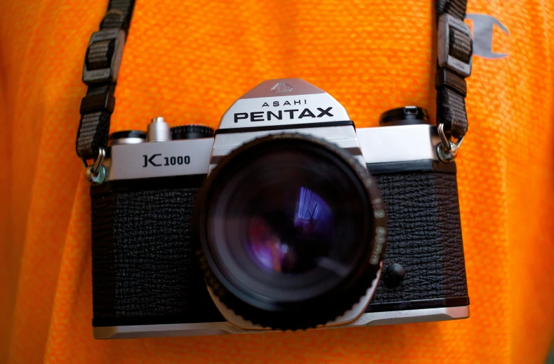 a close up of a person holding a camera, by Adam Rex, pixabay contest winner, photorealism, 1970s cinema camera, pentax k-1000, a photo of an old opened camera, 8k octan advertising photo