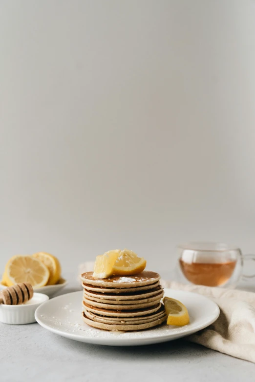 a stack of pancakes sitting on top of a white plate, by Winona Nelson, dau-al-set, lemon, high quality photo, thumbnail, rice