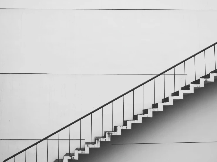 a black and white photo of a set of stairs, by Karl Buesgen, pexels, minimalism, worksafe. instagram photo, getty images, on a wall, integration