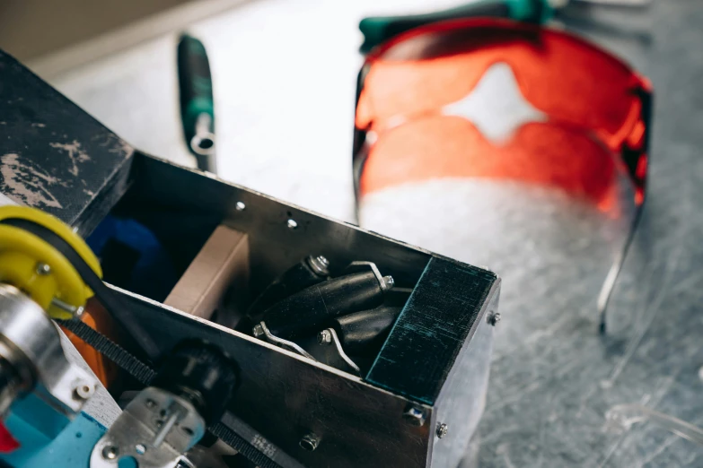 a box filled with tools sitting on top of a table, pexels contest winner, welding helmet head, thumbnail, levers, decoration