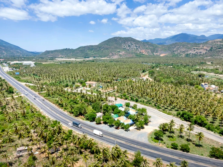 a long stretch of road on the side of a mountain range