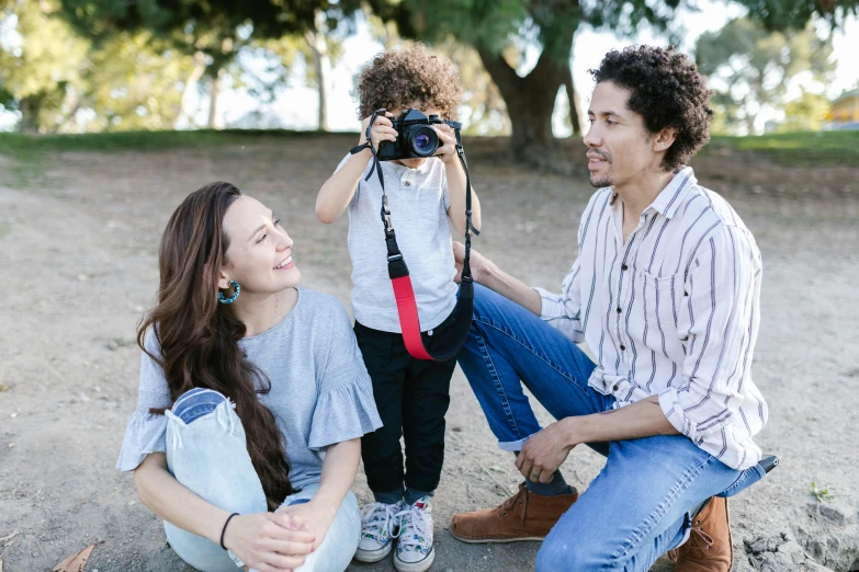 a man taking a picture of a woman and a child, pexels contest winner, hispanic, avatar image, full length shot, smiling at camera