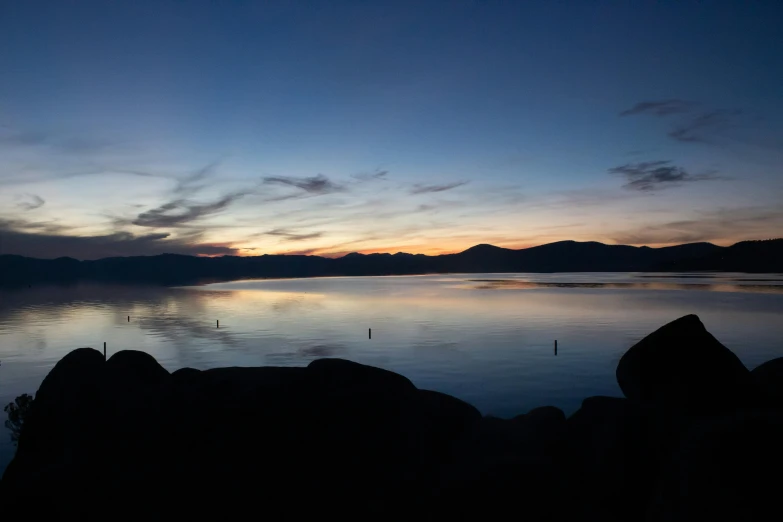 the sun is setting over a body of water, minimalism, big bear lake california, fan favorite, landscape photo-imagery, blue reflections