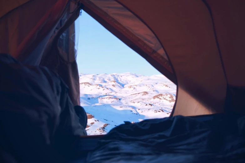 a view of the mountains from inside a tent, by Jessie Algie, trending on unsplash, hurufiyya, snowy arctic environment, lying in bed, brown, nina tryggvadottir