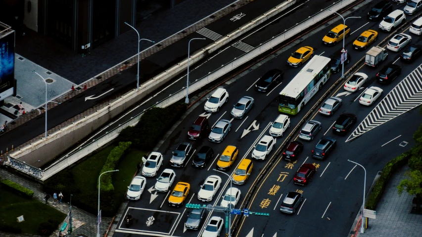 cars are lined up all in a busy city