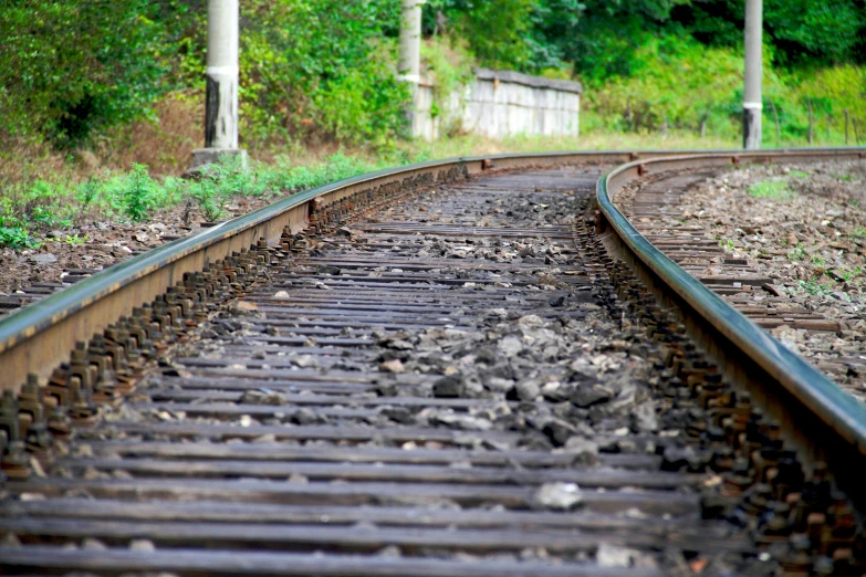 a close up of a train track with trees in the background, unfortunate, university, photo illustration, realistic »
