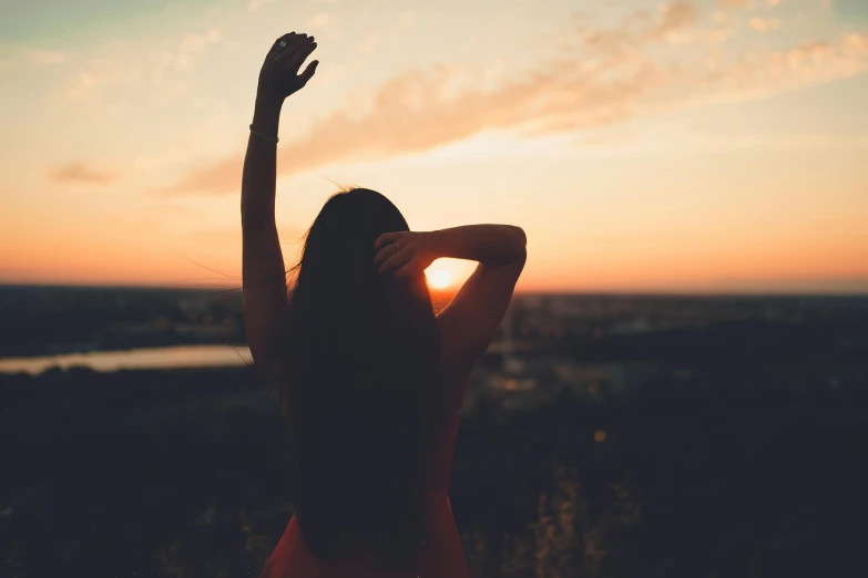 a woman standing on top of a hill at sunset, pexels contest winner, aestheticism, hands in her hair. side-view, girl with dark brown hair, 15081959 21121991 01012000 4k, instagram post