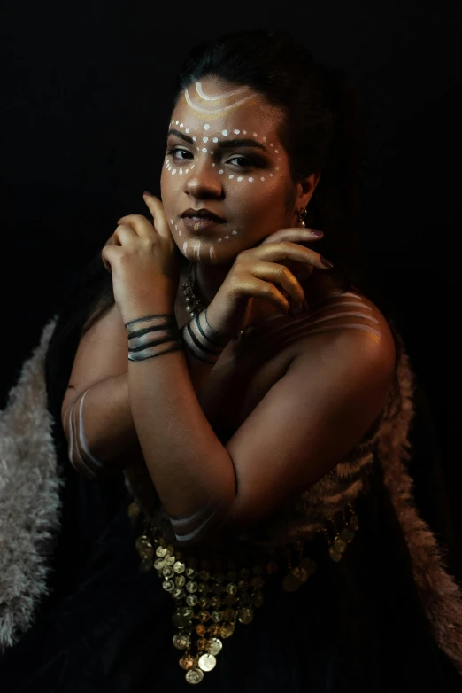 a woman in a black dress posing for a picture, a portrait, unsplash, art photography, tribal makeup, loin cloth, young woman with lynx head, maori