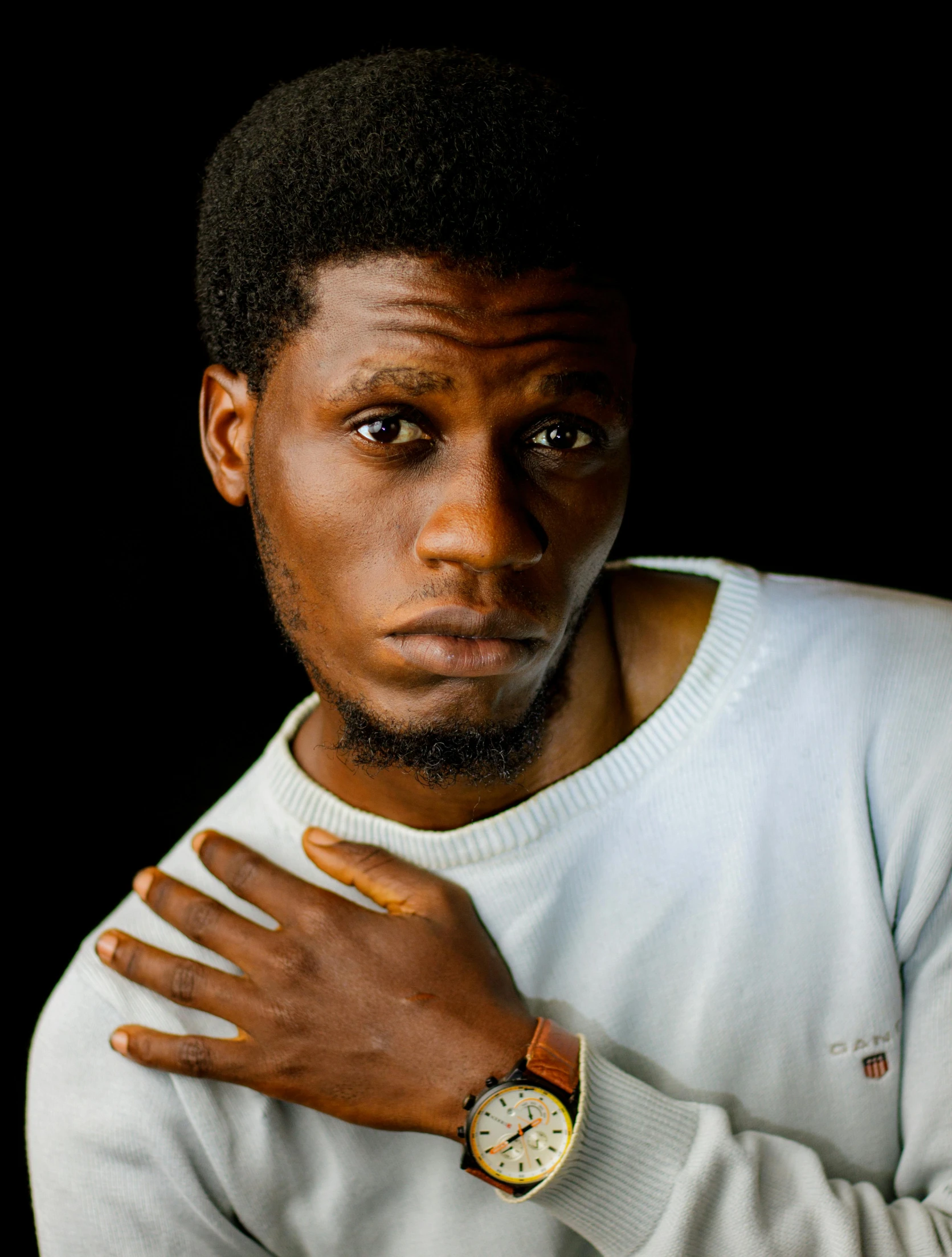 an african american man with a white shirt and orange hands