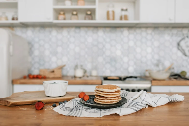 a plate with stack of pancakes on top of it