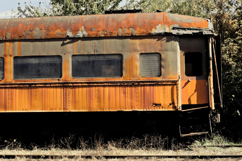 an old rusted train car sitting on the tracks, a portrait, unsplash, ad image, 2000s photo, blank, ignant