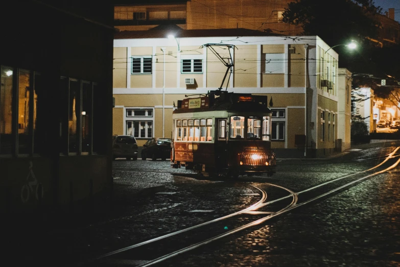 an old cable car is driving on a rainy street