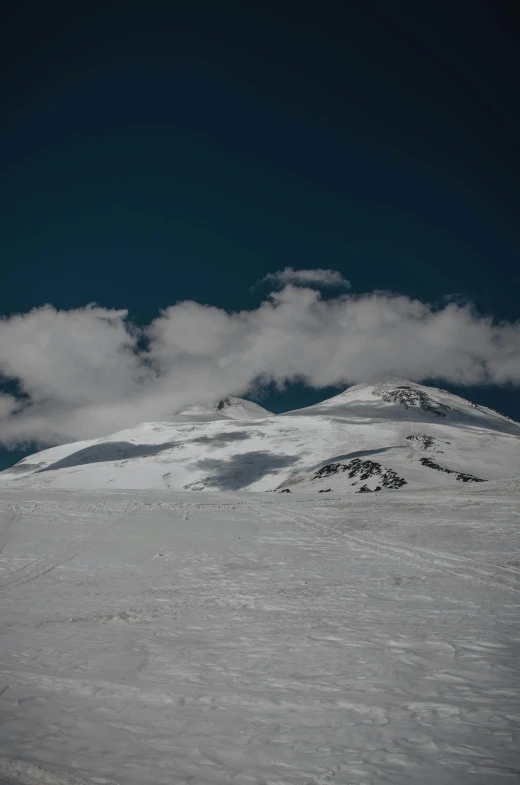 a person is snowboarding over a snowy hill