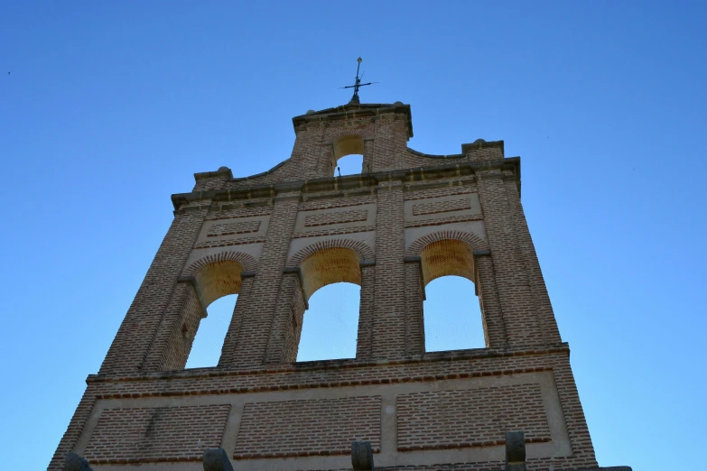 a tall tower with a clock on top of it, by Jan Tengnagel, unsplash, romanesque, bispo do rosario, brick, bells, 3/4 view from below