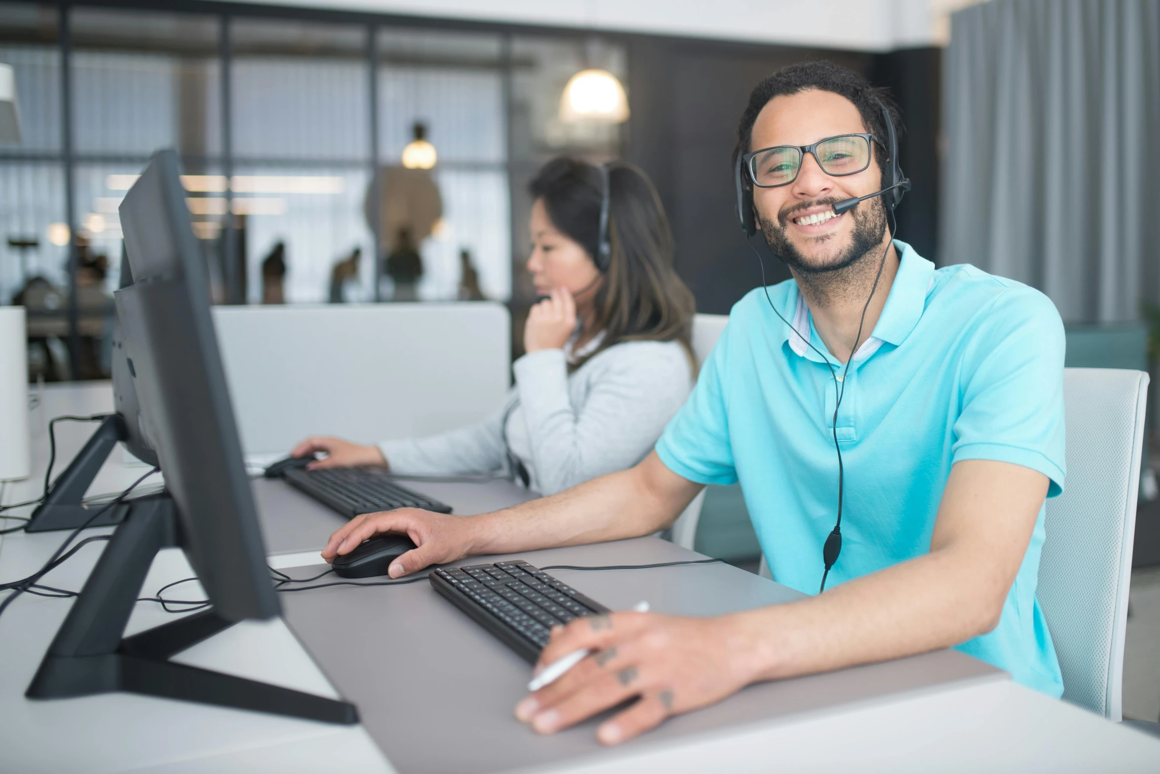 a man wearing a headset sitting in front of a computer, trending on pexels, smiling for the camera, avatar image, central hub, warwick saint